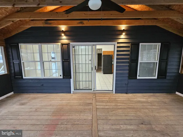 a view of hallway with wooden floor