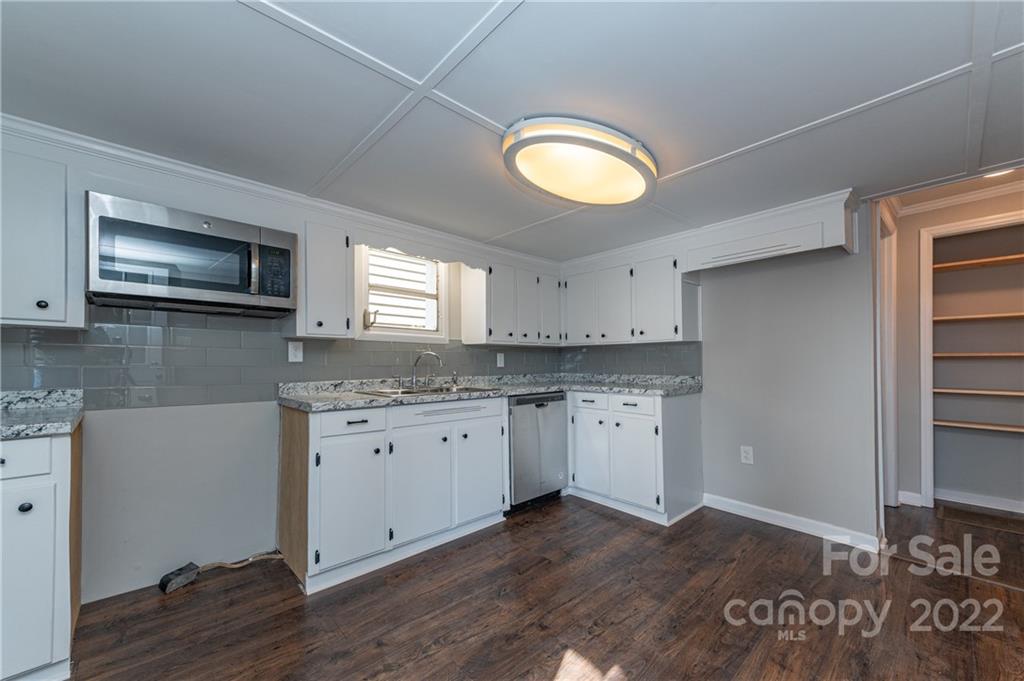 872 State Rd S-29-376 Lancaster, SC 29720 - Photo 6 of 15 a kitchen with granite countertop cabinets stainless steel appliances a sink and a window