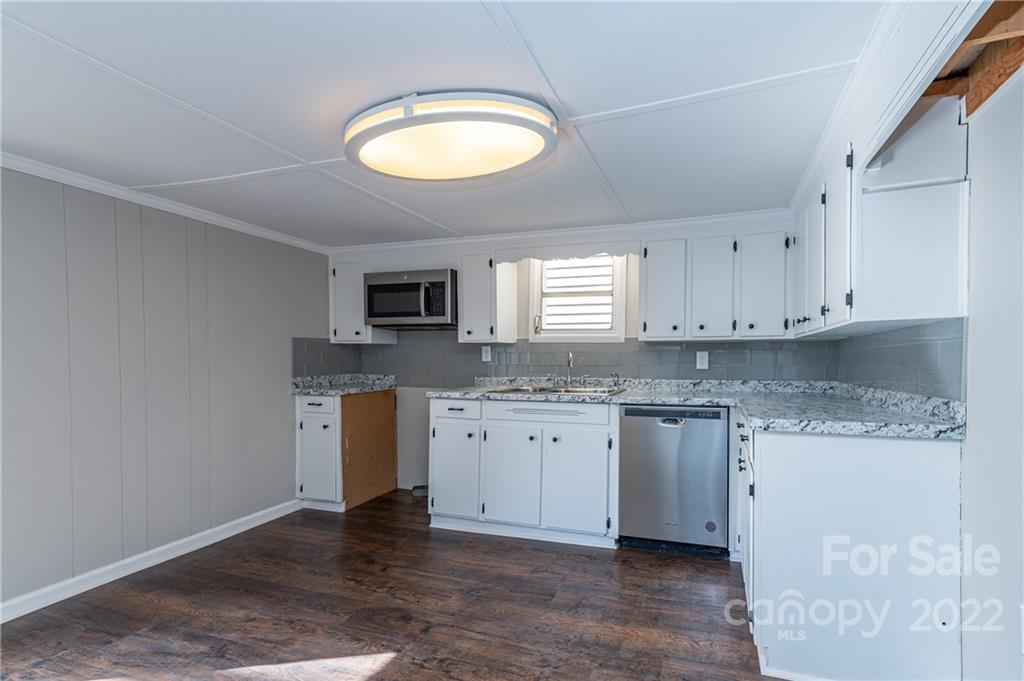 872 State Rd S-29-376 Lancaster, SC 29720 - Photo 7 of 15 a kitchen with granite countertop cabinets stainless steel appliances a sink and a window