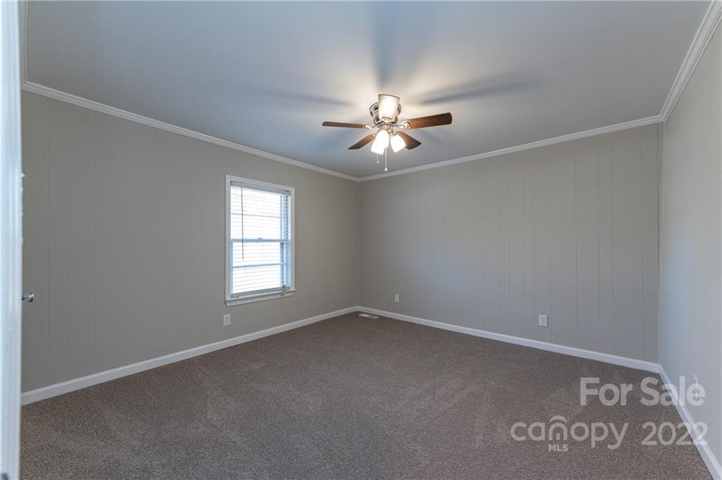 872 State Rd S-29-376 Lancaster, SC 29720 - Photo 9 of 15 an empty room with windows and chandelier fan