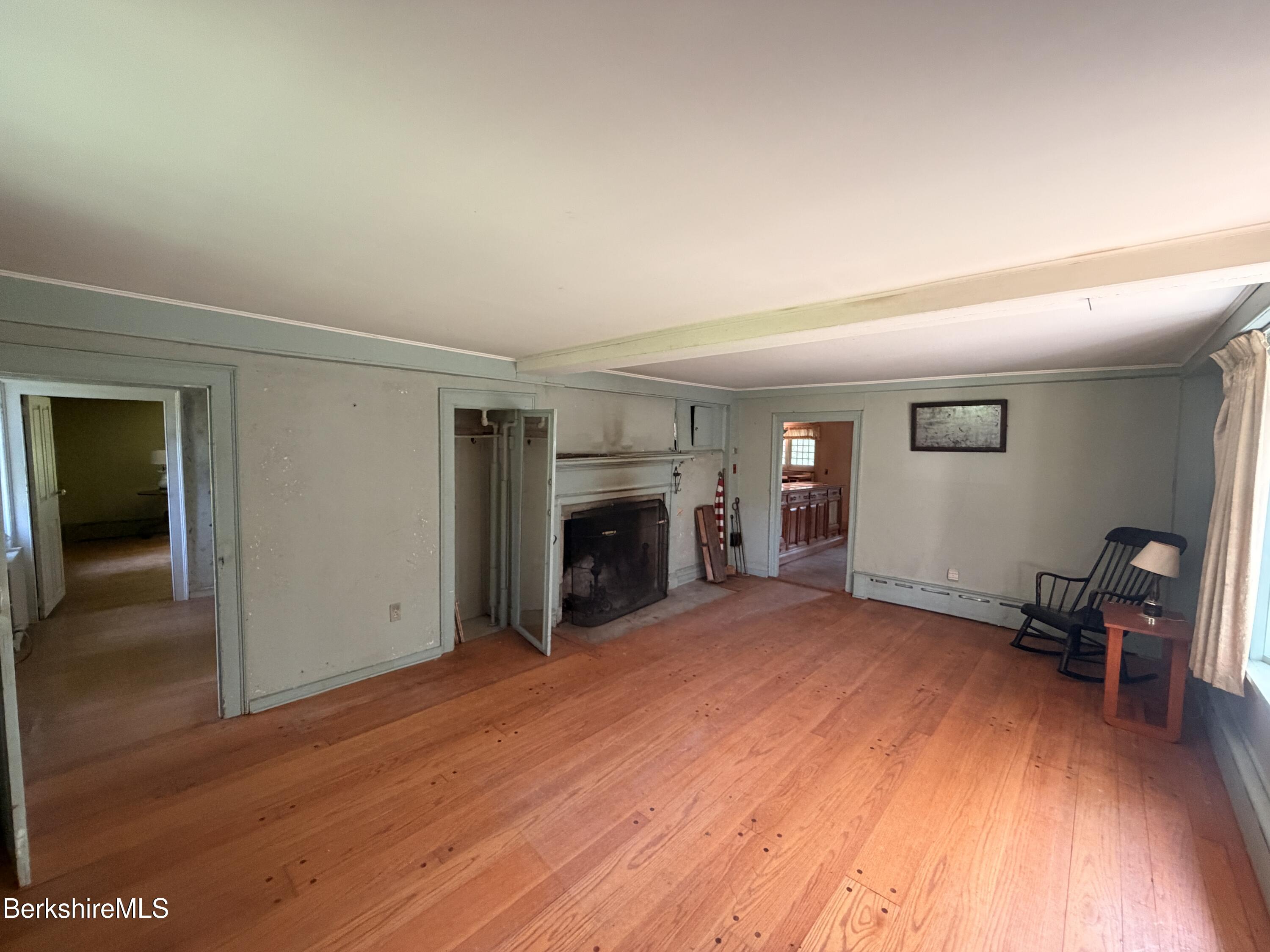 254 Main Street Sheffield, MA 01257 - Photo 6 of 13 a view of empty room with wooden floor and fireplace