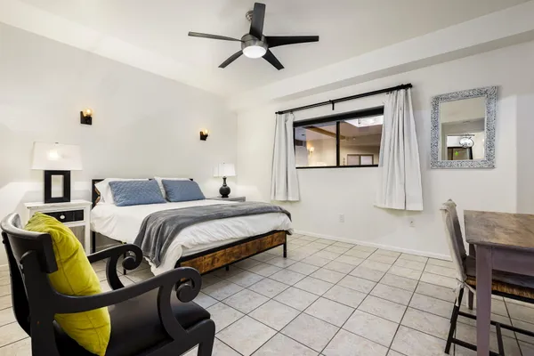 a bedroom with a bed and chair