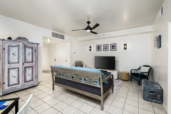 a view of room with kitchen island stainless steel appliances and wooden floor