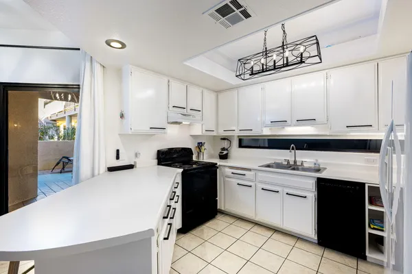 a kitchen with cabinets and stainless steel appliances