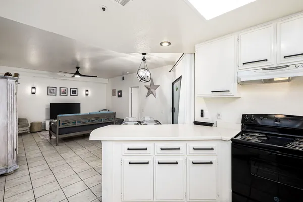 a kitchen with a sink cabinets and window