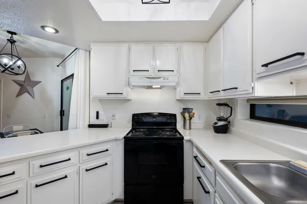 a kitchen with stainless steel appliances kitchen island granite countertop a sink and cabinets