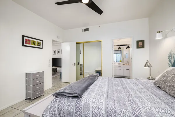 a bedroom with a bed and a table in it