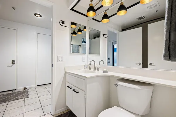 a bathroom with a toilet sink and a mirror