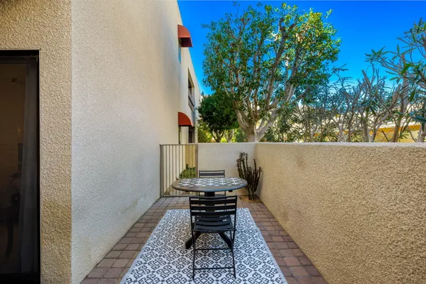a backyard of a house with table and chairs
