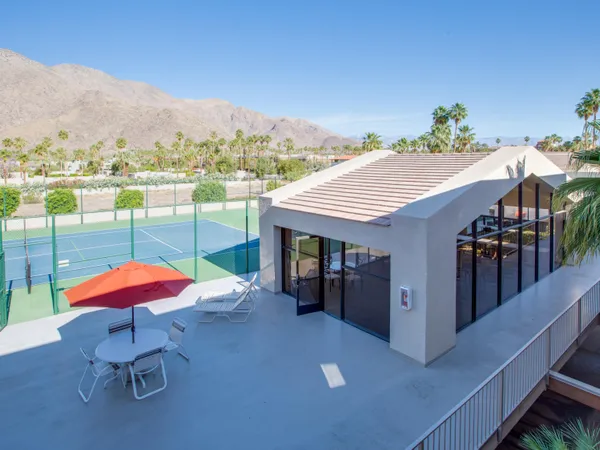 an outdoor space with furniture and umbrella