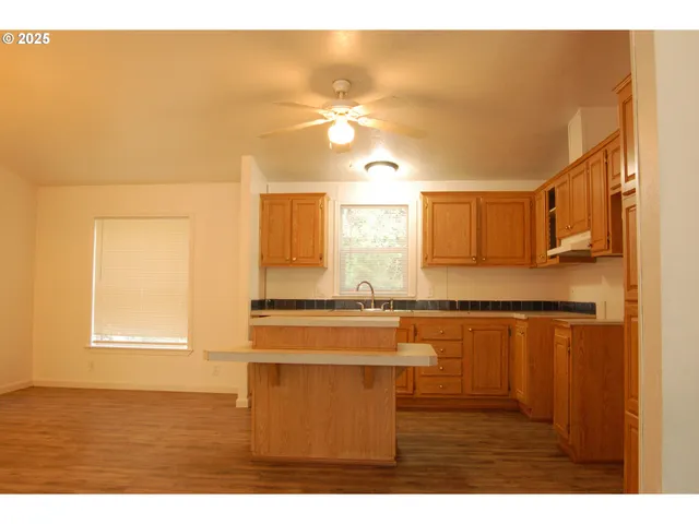 a view of a kitchen with wooden floor