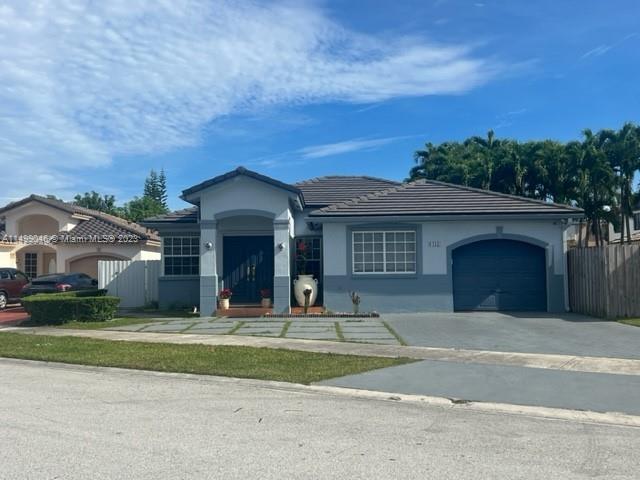 9435 Southwest 156th Place, Unit 9435 Miami, FL 33196 - Photo 1 of 28 a view of a brick house with a big yard and large trees
