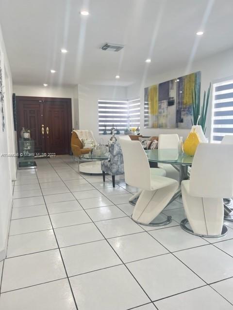 9435 Southwest 156th Place, Unit 9435 Miami, FL 33196 - Photo 13 of 28 a living room with couches and kitchen view with wooden floor