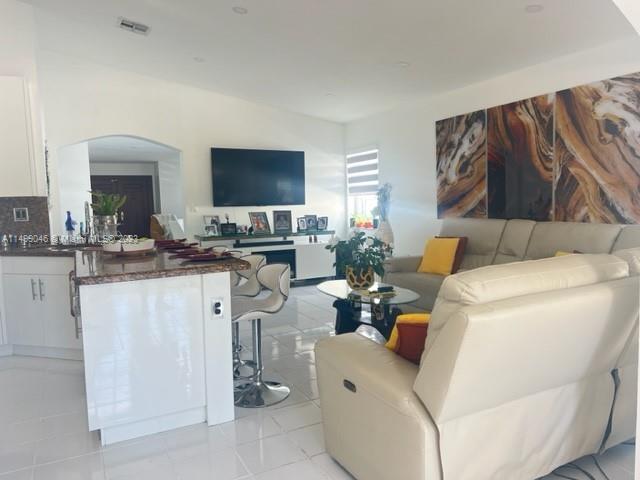 9435 Southwest 156th Place, Unit 9435 Miami, FL 33196 - Photo 17 of 28 a living room with furniture and a flat screen tv