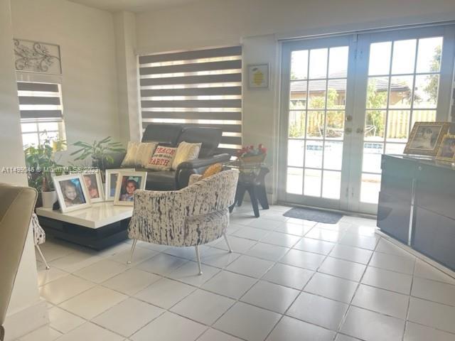 9435 Southwest 156th Place, Unit 9435 Miami, FL 33196 - Photo 20 of 28 a living room with furniture and a large window