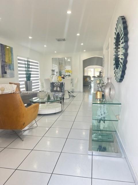 9435 Southwest 156th Place, Unit 9435 Miami, FL 33196 - Photo 2 of 28 a lobby with furniture and floor to ceiling window