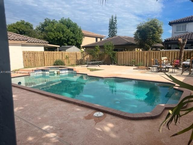 9435 Southwest 156th Place, Unit 9435 Miami, FL 33196 - Photo 21 of 28 a view of a backyard with swimming pool