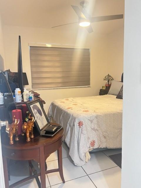9435 Southwest 156th Place, Unit 9435 Miami, FL 33196 - Photo 3 of 28 a bedroom with a bed and a table