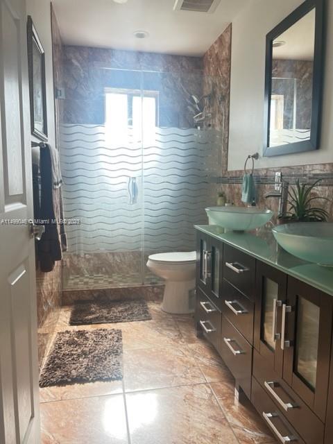 9435 Southwest 156th Place, Unit 9435 Miami, FL 33196 - Photo 4 of 28 a bathroom with a sink toilet and shower