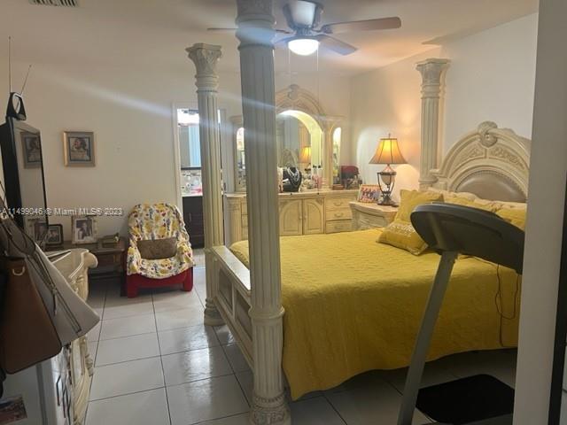 9435 Southwest 156th Place, Unit 9435 Miami, FL 33196 - Photo 6 of 28 a living room with furniture and a flat screen tv