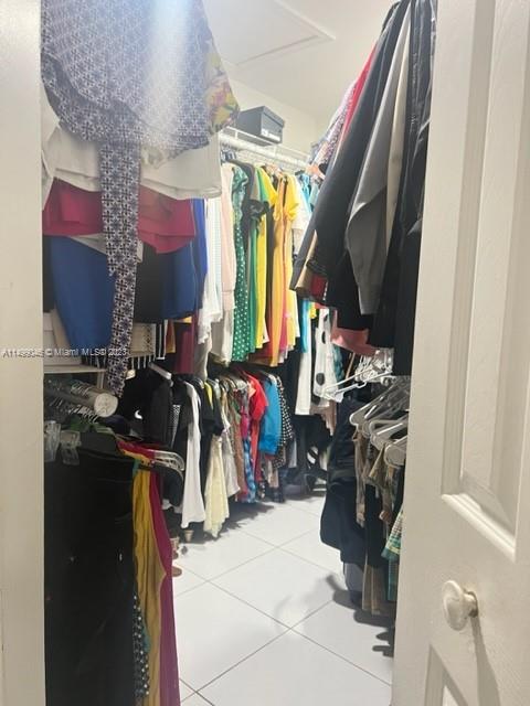 9435 Southwest 156th Place, Unit 9435 Miami, FL 33196 - Photo 10 of 28 a view of walk in closet with clothes and shoes