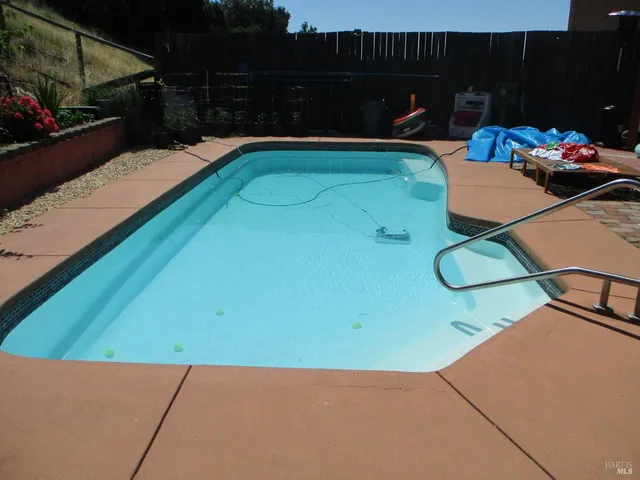 a view of backyard with trampoline