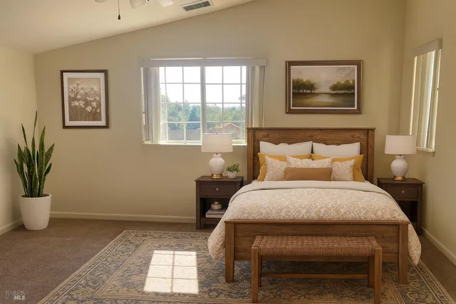 a bed sitting in a bedroom next to a window