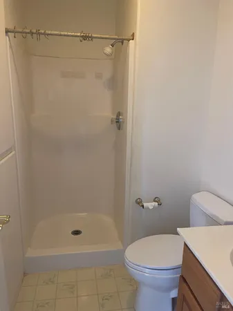 a bathroom with a shower and a toilet