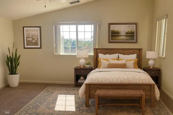 a bed sitting in a bedroom next to a window