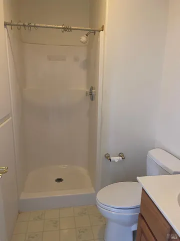 a bathroom with a shower and a toilet