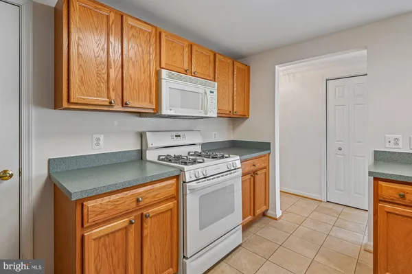 a kitchen with granite countertop cabinets and steel stainless steel appliances