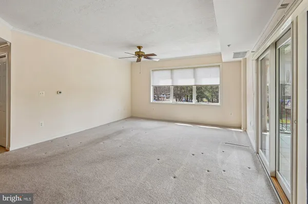 an empty room with windows and closet