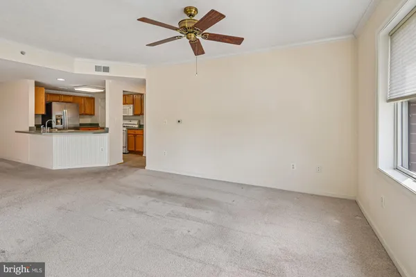 a view of a livingroom with furniture and a ceiling fan