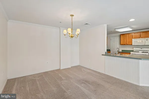 a view of a kitchen with an empty space and a window