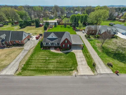 an aerial view of a house with a big yard