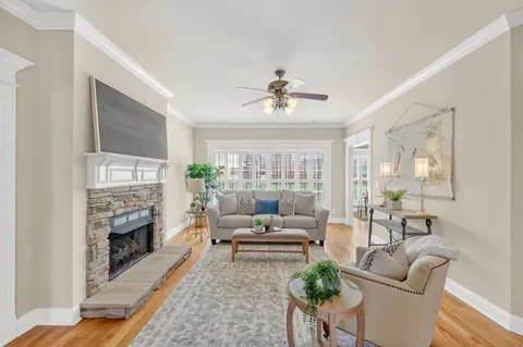 a living room with furniture and a fireplace