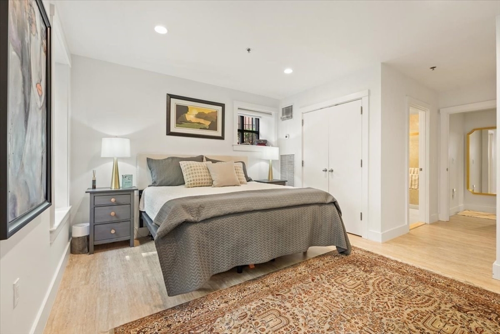 21 Father Francis Gilday Street, Unit 114 Boston, MA 02118 - Photo 13 of 28 a bedroom with a bed and a painting
