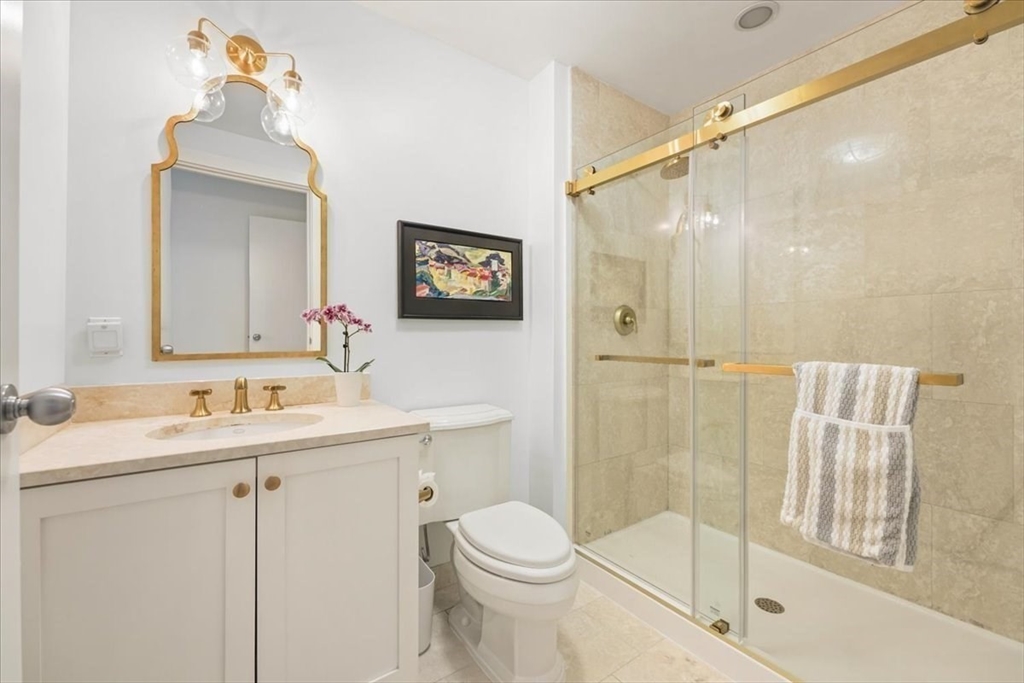 21 Father Francis Gilday Street, Unit 114 Boston, MA 02118 - Photo 14 of 28 a bathroom with a toilet a sink and a mirror