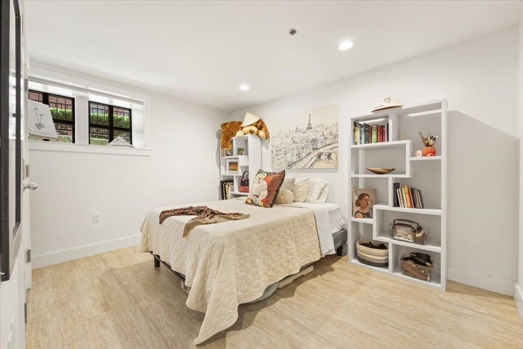 21 Father Francis Gilday Street, Unit 114 Boston, MA 02118 - Photo 15 of 28 a bedroom with a bed and a book shelf