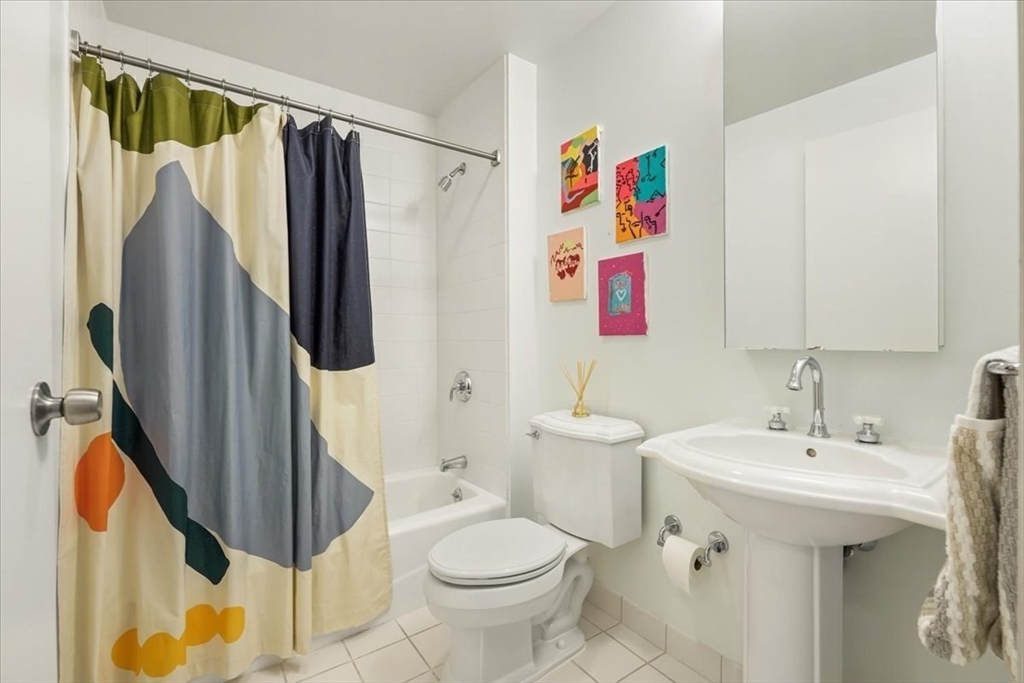 21 Father Francis Gilday Street, Unit 114 Boston, MA 02118 - Photo 16 of 28 a bathroom with a sink toilet and shower