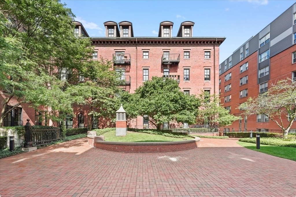 21 Father Francis Gilday Street, Unit 114 Boston, MA 02118 - Photo 25 of 28 a front view of a building with a yard and trees