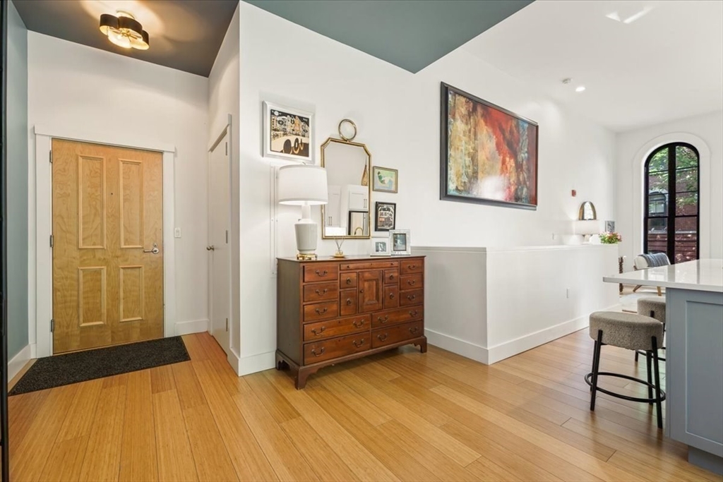 21 Father Francis Gilday Street, Unit 114 Boston, MA 02118 - Photo 6 of 28 a bedroom with a bed and a table