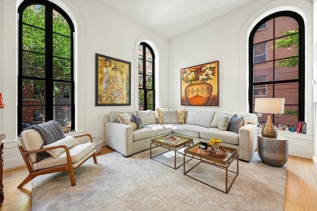 21 Father Francis Gilday Street, Unit 114 Boston, MA 02118 - Photo 10 of 28 a living room with furniture a large window and a flat screen tv