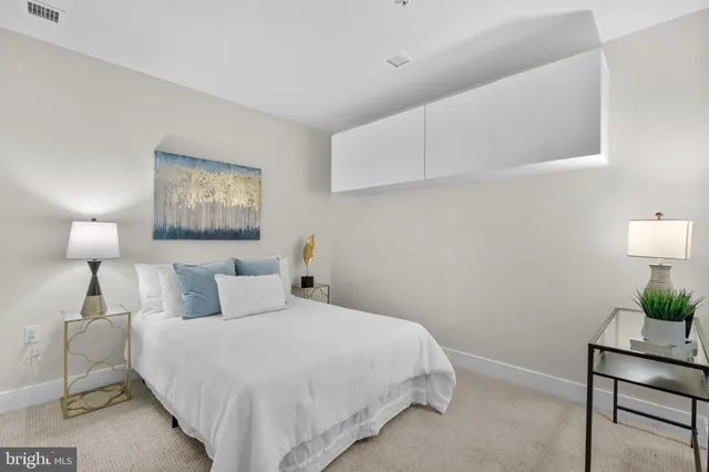 a bedroom with a bed and a lamp