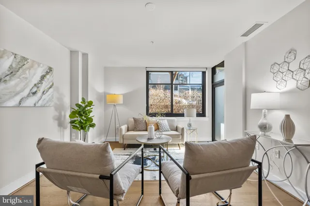a living room with furniture and a lamp