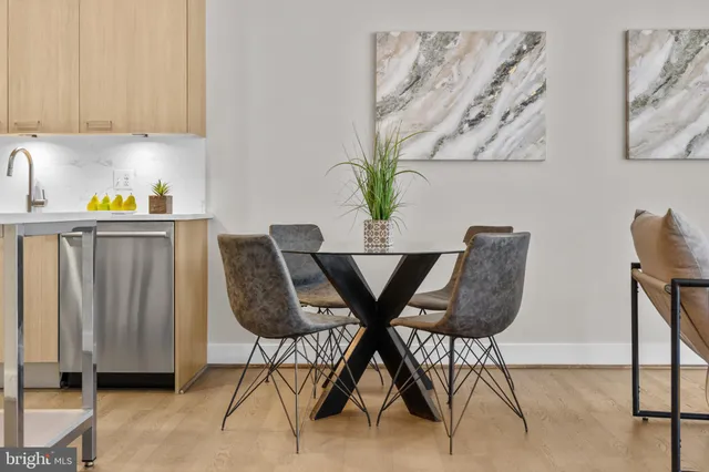 a dining room with furniture and wooden floor