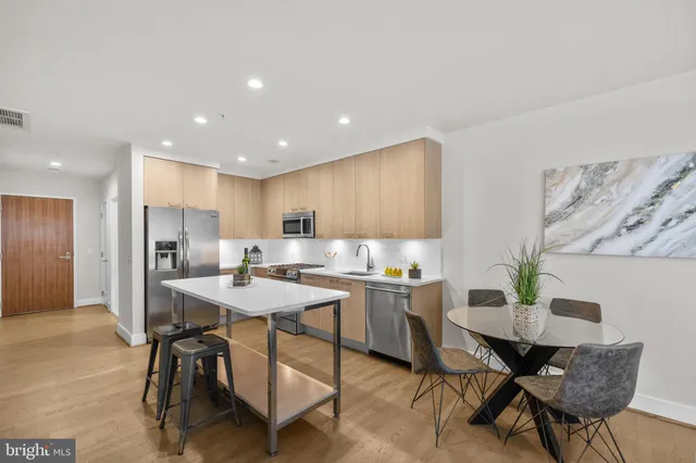 a kitchen with a table and chairs in it