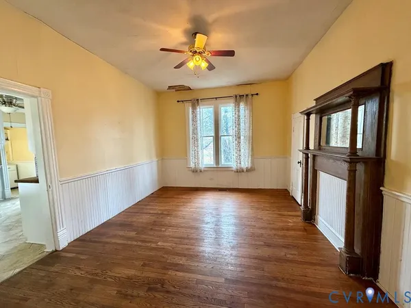 wooden floor in an empty room with a window
