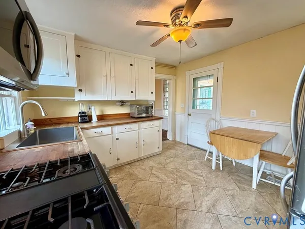 a kitchen with a stove a sink and cabinets
