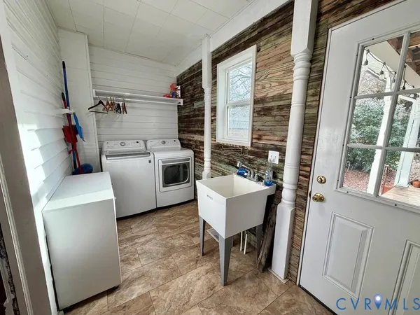 a utility room with sink dryer and washer